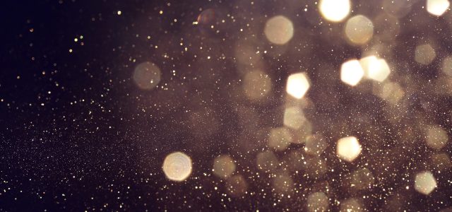 background of abstract glitter lights. gold and black. de focused. banner